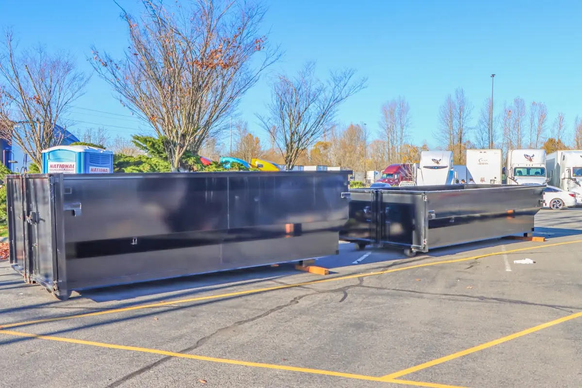 Professional dumpster rental service with roll-off container on residential driveway in Vashon